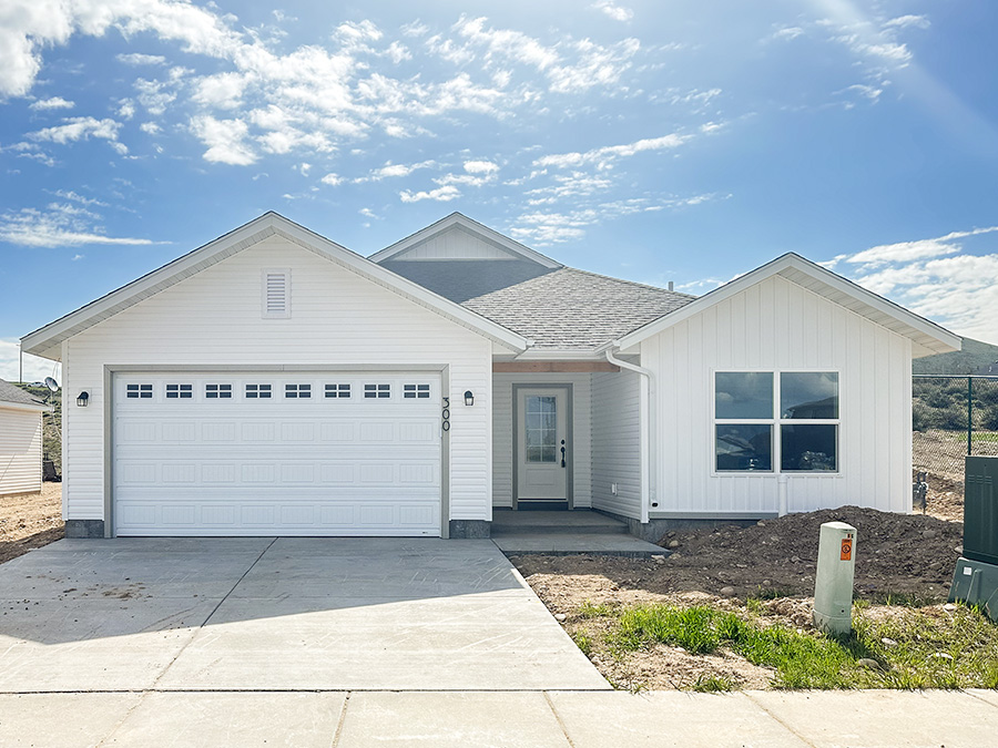Classic white home with near-black shingles, windows with mullions